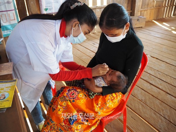 코이카 캄보디아 동북부 소외지역 모자보건 프로그램의 일환으로 라타나끼리 지역 내 보건소 조산사가 ‘찾아가는 서비스’를 통해 영유아의 구강백신(OPV) 예방접종을 하는 모습 (사진 코이카)